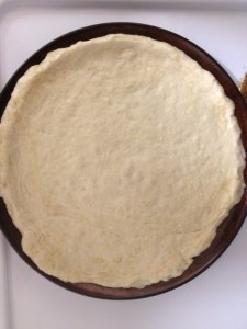 The first step in making our family pizza is getting the crust ready.